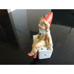 beeldje, pierrot, clown, zit op 2 dobbelstenen, rode muts